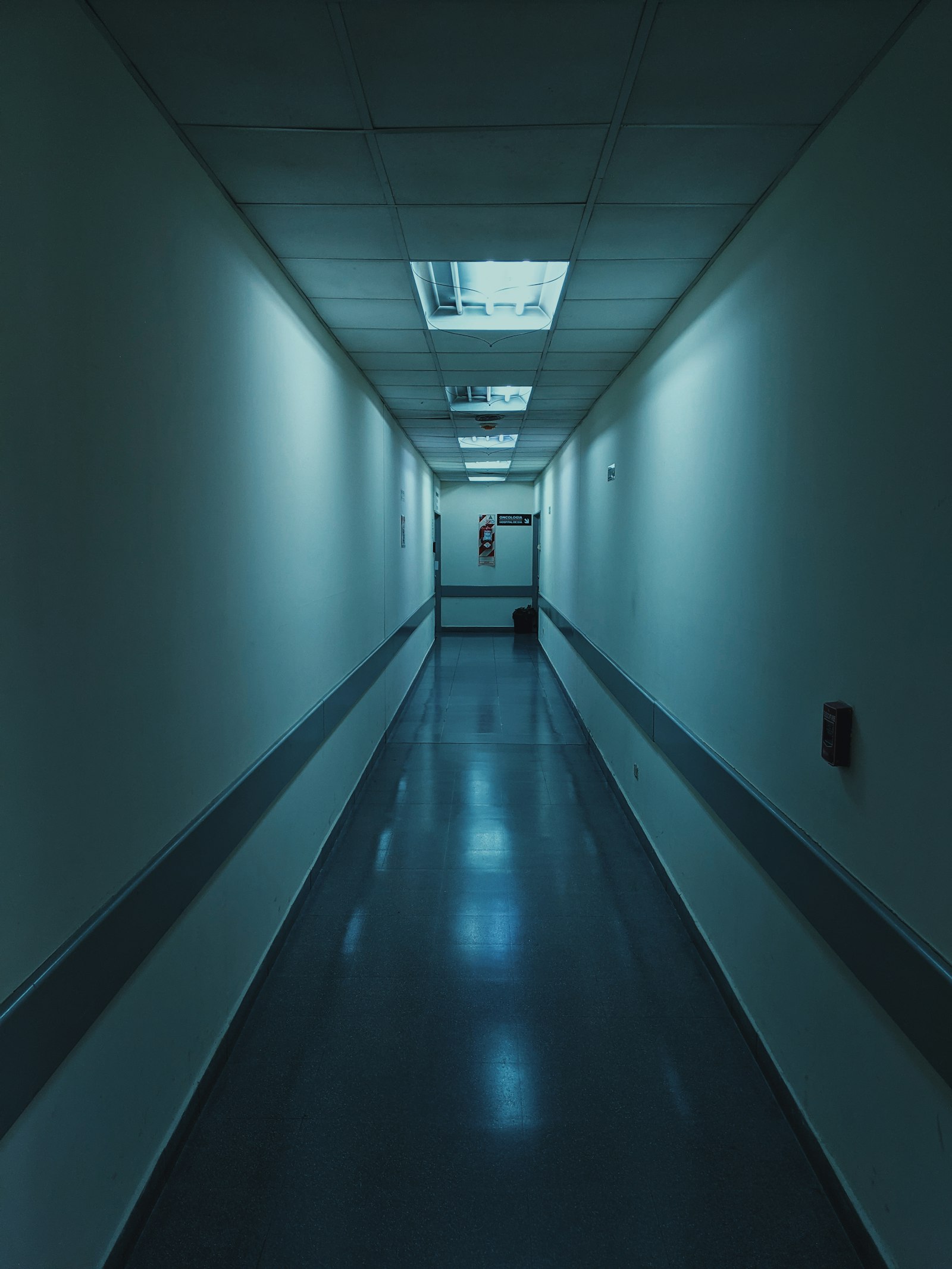 A cool blue-lit healthcare corridor