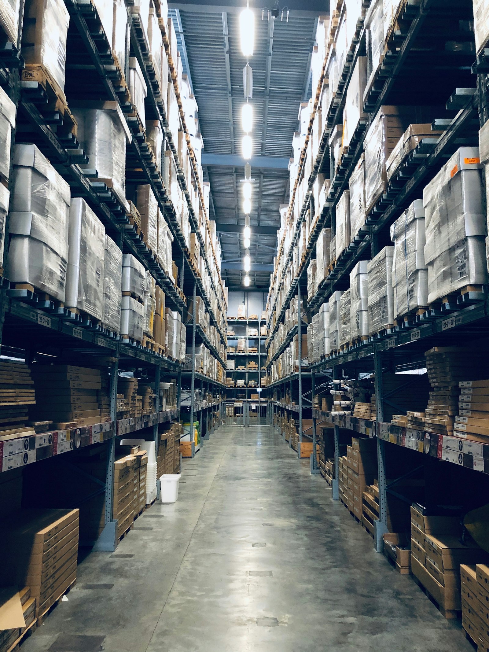 Tall storage racks lining the aisles of a distribution warehousing