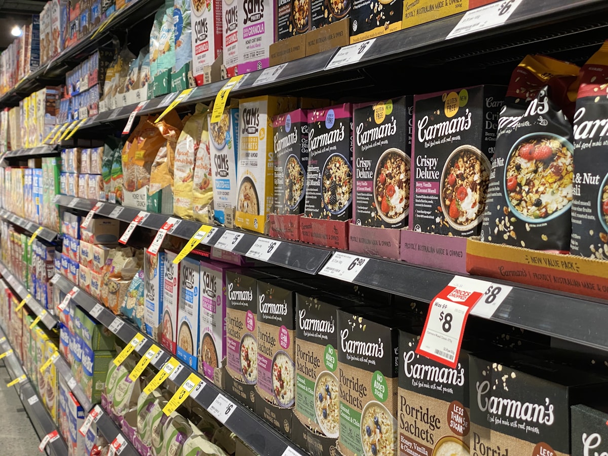 Well-stocked retail grocery shelves lined with neatly faced packaged goods