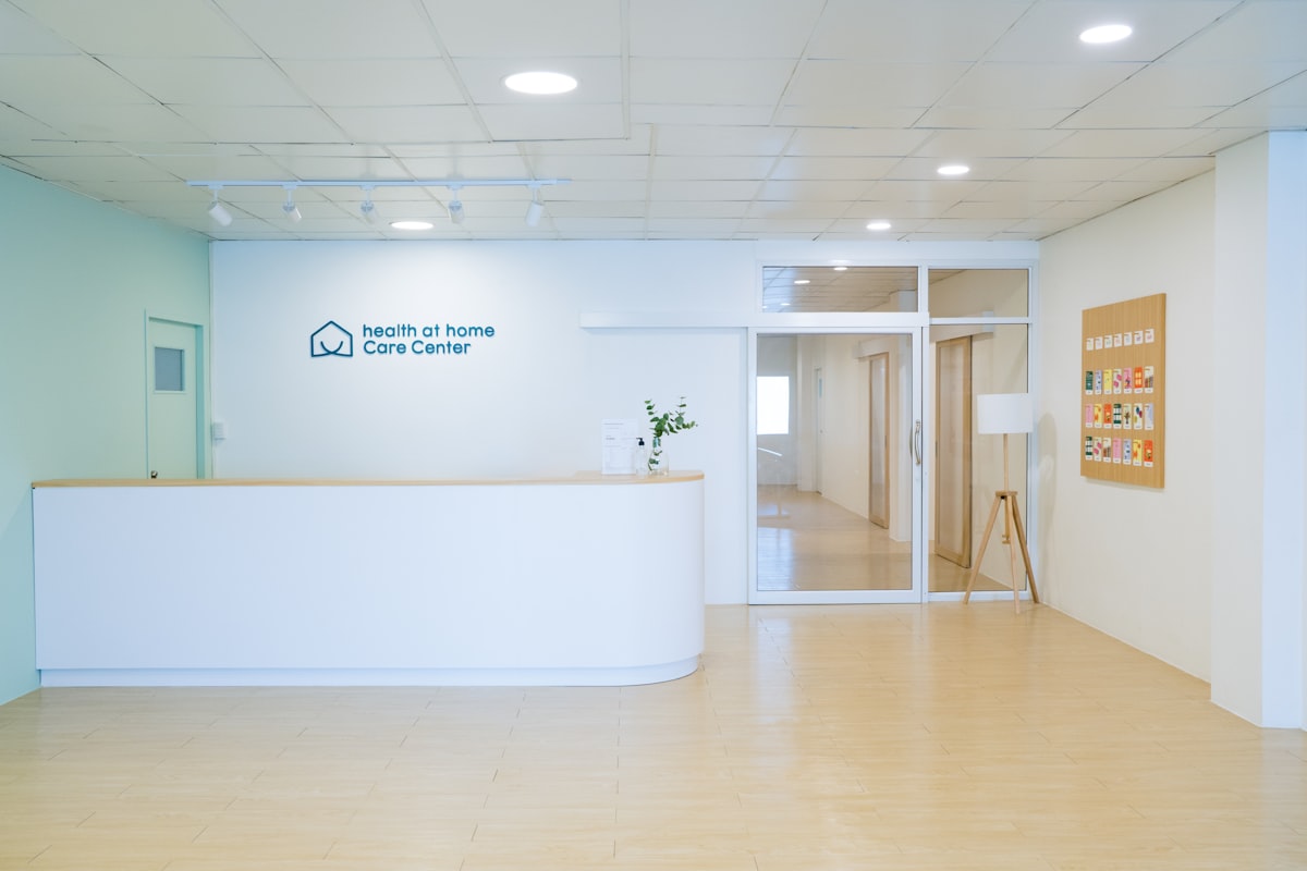 Clean, modern clinic reception desk in a bright, newly set up care-center lobby